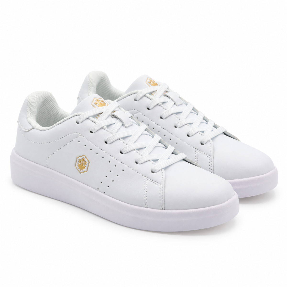 A pair of white low-top sneakers with small gold geometric logo accents on the side and tongue, shown on a clean white background.