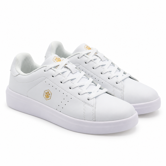 A pair of white low-top sneakers with small gold geometric logo accents on the side and tongue, shown on a clean white background.