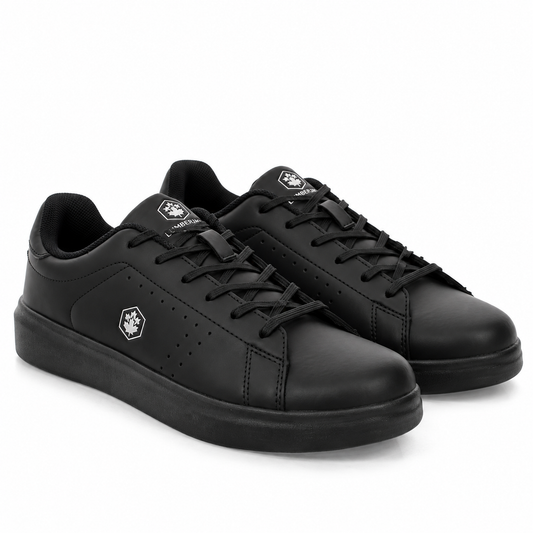 A pair of black low-top sneakers with matching black laces and soles, featuring a small white geometric logo on the side and tongue, set against a plain white background.