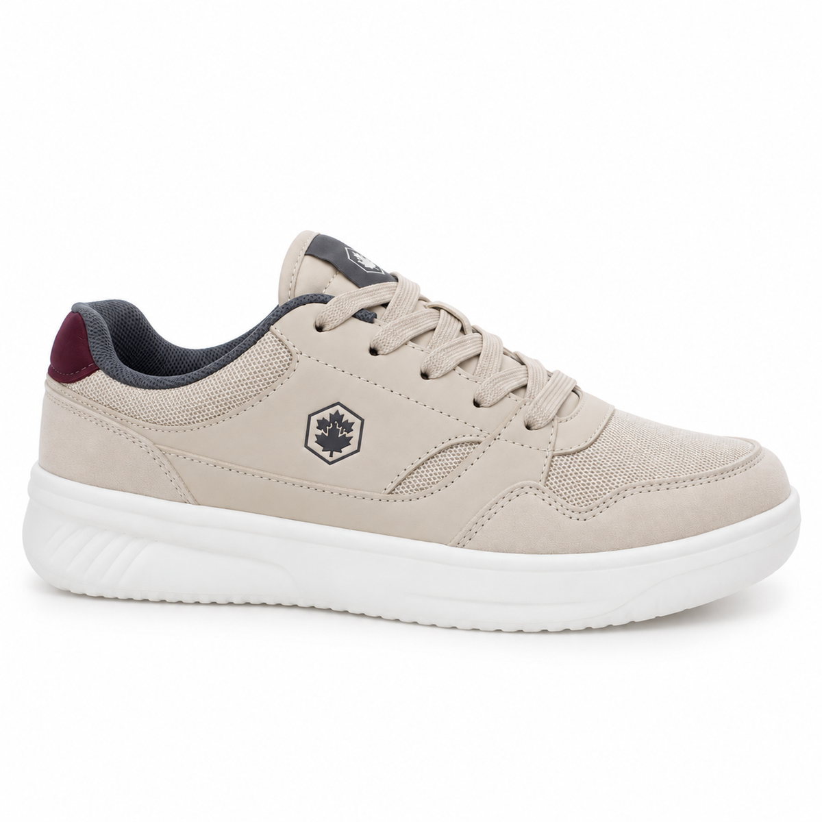 A low-top casual sneaker in light beige suede and mesh with a thick white sole, featuring a dark gray hexagonal logo on the side and a dark burgundy heel accent.